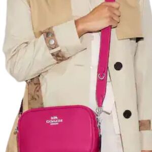 Coach Jamie pebble leather camera bag. Color is fuschia with silver hardware.